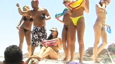Endearing babes with nice tits and asses have fun on the sunny beach