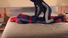 Two horny gay friends in Spiderman costume having rough sex on the bed